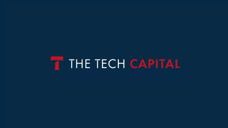 Logo of "The Tech Capital" with a dark blue background. The text is in white and red, with a stylized "T" icon on the left.