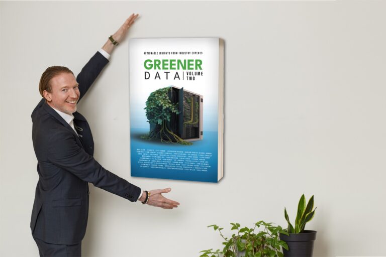 Man in a suit smiling and gesturing towards an enlarged book cover titled "Greener Data", with a plant beneath.