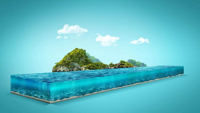 A diorama features a section of ocean with clear water, sandy bottom, and a small lush island under a blue sky with clouds.