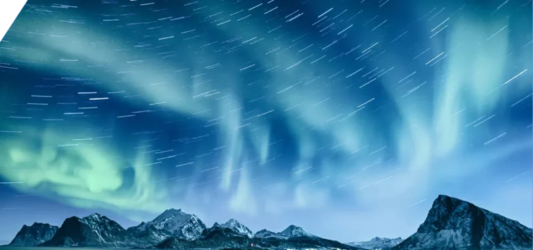 A vivid aurora borealis illuminates the night sky over a mountainous landscape, with visible star trails, casting a serene light on nearby sustainable data centers.