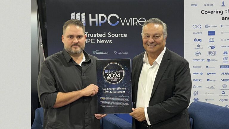 Two men presenting an award plaque for "Top Energy-Efficient HPC Achievement" at an event, standing in front of a display with company logos.