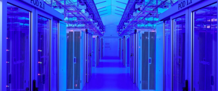 The corridor in the cutting-edge data center features rows of server racks on both sides, all bathed in an ambient blue glow.