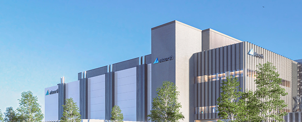 Modern data center building with the "Alamortii" logo, surrounded by trees, under a clear blue sky.