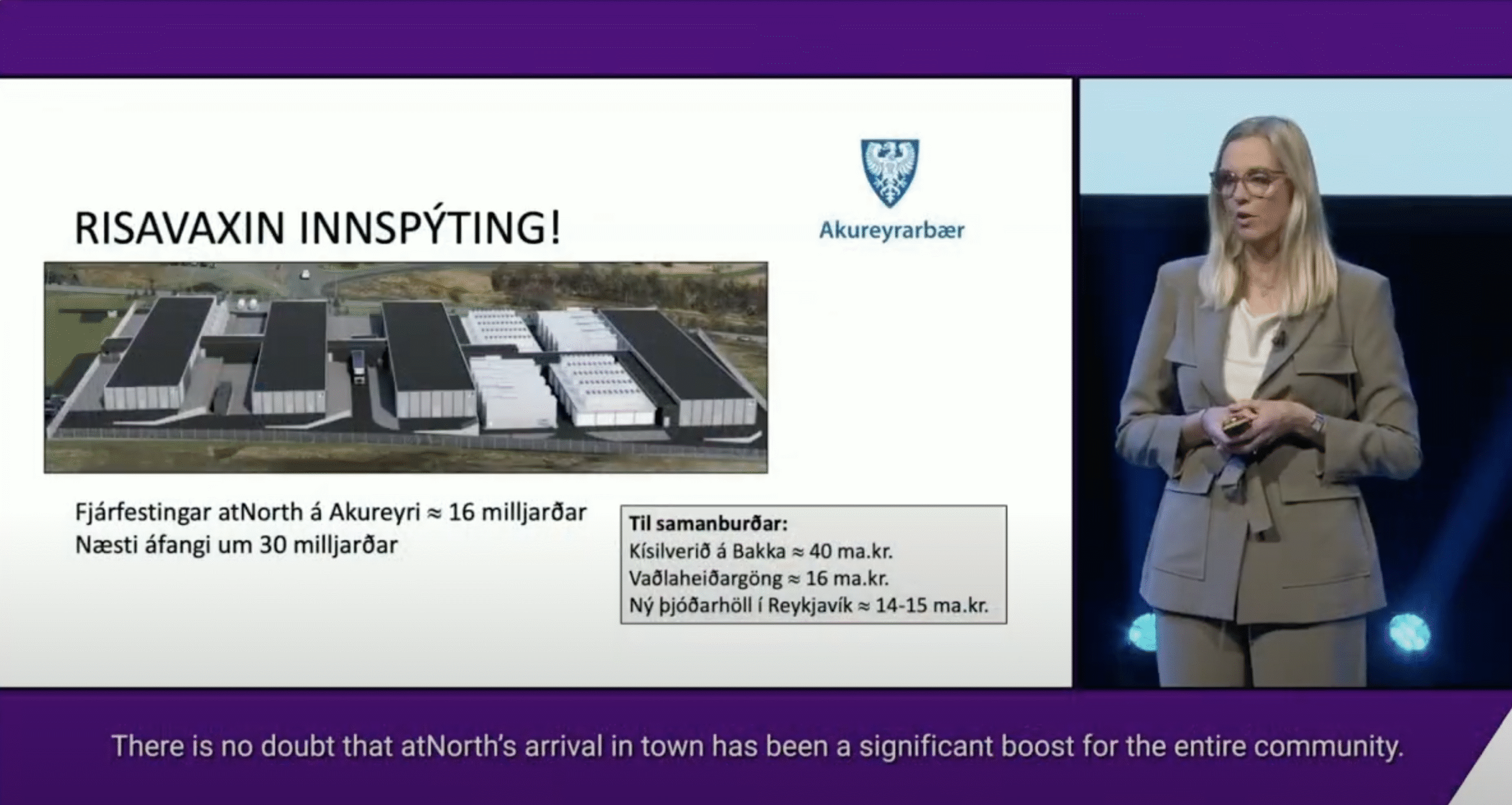 A woman presents a slide about atNorth’s investment in Akureyri, showing an aerial image of a data center and details of the project in Icelandic, with English subtitles at the bottom.