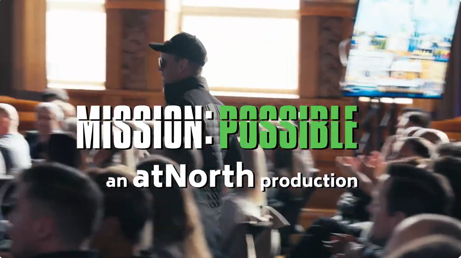 A person in a cap walks through a seated audience. Overlaid text reads "MISSION: POSSIBLE, an atNorth production.