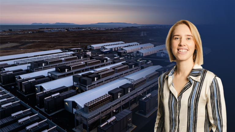 A woman smiling in front of an aerial view of a data center facility.