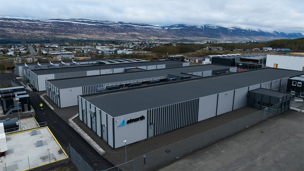 Aerial view of an AI-ready atNorth data center complex located in a valley with mountains in the background.